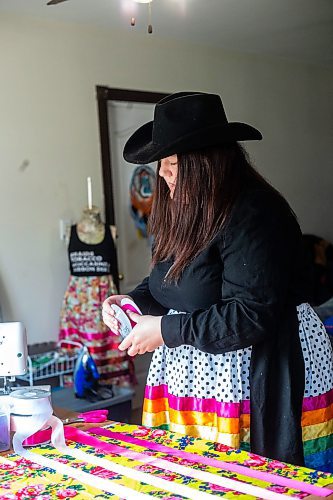 MIKAELA MACKENZIE / WINNIPEG FREE PRESS
 
Marlena Muir, founder of Metis Superstar Designs, works on a skirt in her home where she makes contemporary ribbon skirts in Selkirk on Wednesday, May 10, 2023. For Dave story.

Winnipeg Free Press 2023.