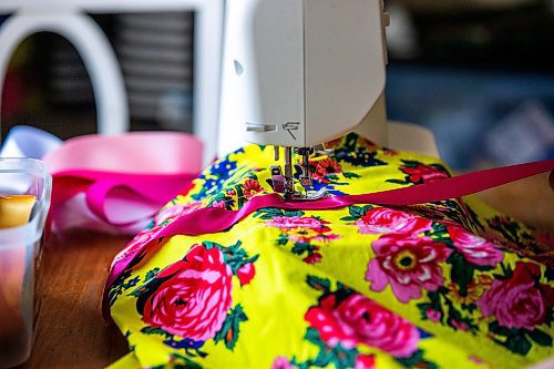 MIKAELA MACKENZIE / WINNIPEG FREE PRESS
 
Marlena Muir, founder of Metis Superstar Designs, works on a skirt in her home where she makes contemporary ribbon skirts in Selkirk on Wednesday, May 10, 2023. For Dave story.

Winnipeg Free Press 2023.