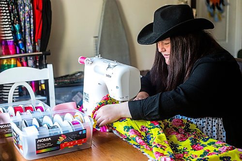 MIKAELA MACKENZIE / WINNIPEG FREE PRESS
 
Marlena Muir, founder of Metis Superstar Designs, works on a skirt in her home where she makes contemporary ribbon skirts in Selkirk on Wednesday, May 10, 2023. For Dave story.

Winnipeg Free Press 2023.