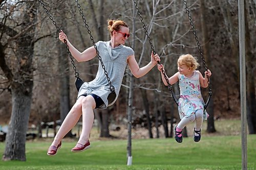 11052023
Erin Dyck and her daughter Alice, four, swing together at Victoria Park in Souris on a hot Thursday. 
(Tim Smith/The Brandon Sun)