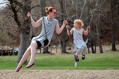 Erin Dyck and her four-year-old daughter, Alice, swing together at Victoria Park in Souris on Thursday. (Tim Smith/The Brandon Sun)