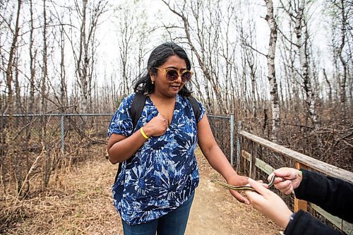 MIKAELA MACKENZIE / WINNIPEG FREE PRESS
 
AV Kitching touches a snake as Cara Lizotte holds it out for her at the Narcisse Snake Dens on Friday, May 12, 2023. For AV story.

Winnipeg Free Press 2023.