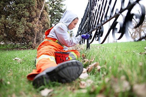 12052023
Taylor O&#x2019;Rourke with the City of Brandon Parks and Recreation Services works alongside other crew members to repaint the fence that lines the Brandon Cemetery along 18th Street on Friday. Workers spent the week removing rust from the fence and repainting it.
(Tim Smith/The Brandon Sun)