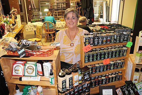 Merla Kreuger sells a variety of Watkins products at Saturday's Global Market that took place at the Building Re-Fit Store in downtown Brandon. (Kyle Darbyson/The Brandon Sun) 