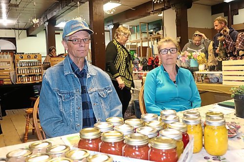 Loyd and Barbara Dyck of Forrest sell their fruit preserves and home-grown vegetables at Saturday's Global Market in downtown Brandon. (Kyle Darbyson/The Brandon Sun)