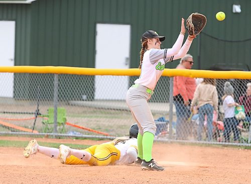 Under-17 Westman Magic base runner Ella Young (14) dives back to the bag safely as Eastman Wildcats first baseman Danyel Heppner waits to catch the ball during Manitoba Premier Softball League action on Saturday afternoon at the Ashley Neufeld Softball Complex. (Perry Bergson/The Brandon Sun)