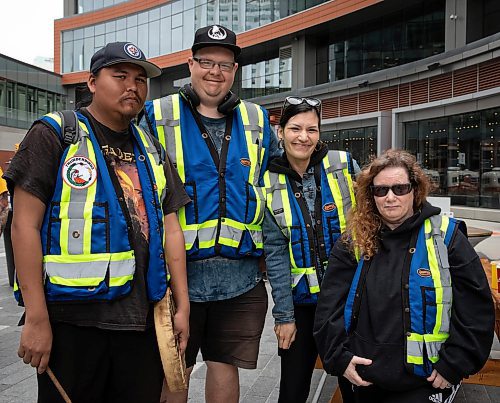 JESSICA LEE / WINNIPEG FREE PRESS

From left to right: Billy, Trevor (Enibe Mukwe) Keri and Jeje, all members of Thunderbirdz patrol group, are photographed May 13, 2023 at True North Square. Patrol groups of about a hundred patrolled around the downtown core, handing out water and snacks.

Reporter: Gabby Piche