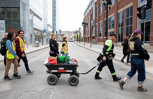 JESSICA LEE / WINNIPEG FREE PRESS

A patrol group is photographed May 13, 2023 near True North Square. About a hundred volunteers patrolled around the downtown core, handing out water and snacks.

Reporter: Gabby Piche