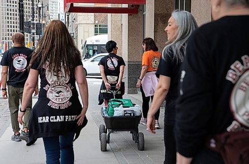 JESSICA LEE / WINNIPEG FREE PRESS

Brenda Jones pulls a wagon of supplies May 13, 2023 near True North Square. About a hundred volunteers patrolled around the downtown core, handing out water and snacks.

Reporter: Gabby Piche