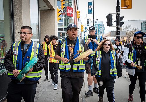 JESSICA LEE / WINNIPEG FREE PRESS

Billy (centre) hits his drum while walking around the downtown core with Thunderbirdz patrol group May 13, 2023. About a hundred volunteers patrolled around the downtown core, handing out water and snacks.

Reporter: Gabby Piche