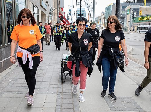 JESSICA LEE / WINNIPEG FREE PRESS

From left to right: Cindy Porsche, Brenda Jones and Bonnie Leslie walk with their patrol group May 13, 2023 on Portage Ave. The groups of about a hundred patrolled around the downtown core, handing out water and snacks.

Reporter: Gabby Piche
