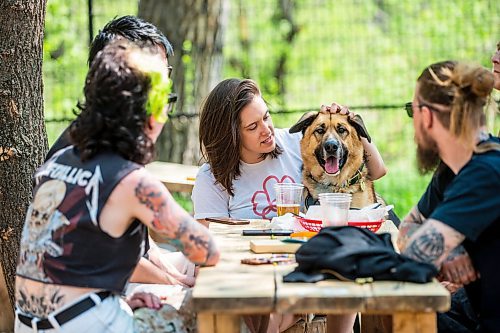 MIKAELA MACKENZIE / WINNIPEG FREE PRESS
 
Dayna Price and her dog, Jude, hang out with friends at The Beer Can on Monday, May 15, 2023. For patio Wasney story.

Winnipeg Free Press 2023.