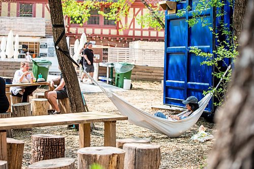 MIKAELA MACKENZIE / WINNIPEG FREE PRESS
 
Marina Koslock hangs out in a hammock at The Beer Can on Monday, May 15, 2023. For patio Wasney story.

Winnipeg Free Press 2023.