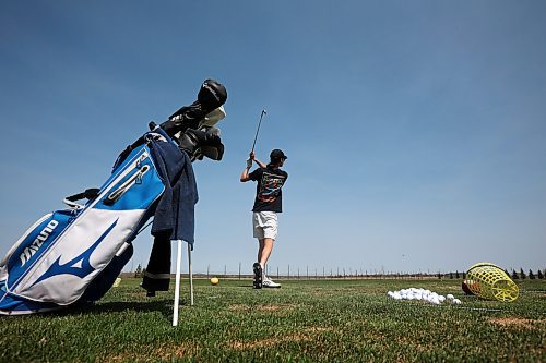 11052023
Leo McArthur of Brandon hits some balls at Mulligan's Driving Range west of Brandon on Highway 1A on a hot and sunny Monday afternoon.
(Tim Smith/The Brandon Sun)