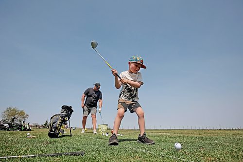 11052023
Father and son Ryan and Harlin Stokes tee up at Mulligan's Driving Range west of Brandon on Highway 1A on a hot and sunny Monday afternoon.
(Tim Smith/The Brandon Sun)