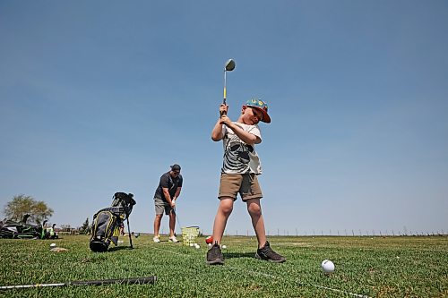 11052023
Father and son Ryan and Harlin Stokes tee up at Mulligan's Driving Range west of Brandon on Highway 1A on a hot and sunny Monday afternoon.
(Tim Smith/The Brandon Sun)