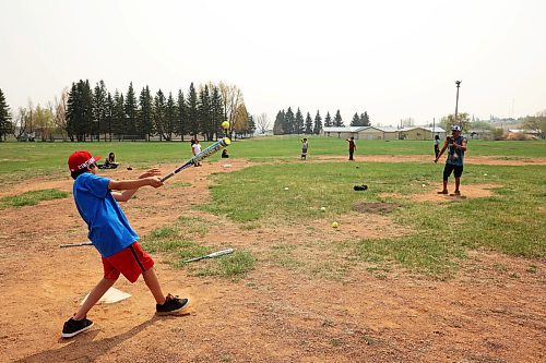 16052023
Nash Ironman, a grade 5/6 student from Sioux Valley Elementary School, hits the ball while playing baseball with other students during recess at the school on a hot and smokey Tuesday afternoon. 
(Tim Smith/The Brandon Sun)