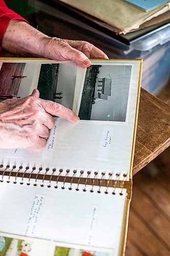 MIKAELA MACKENZIE / WINNIPEG FREE PRESS
 
Joan Wheeler points out a photo of the school being moved in an album at Star Mound School, where she attended when she was young, near Snowflake, Manitoba on Wednesday, May 17, 2023. For Al Small story.

Winnipeg Free Press 2023.