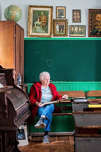 MIKAELA MACKENZIE / WINNIPEG FREE PRESS
 
Joan Wheeler looks at photos in an album at Star Mound School, where she attended when she was young, near Snowflake, Manitoba on Wednesday, May 17, 2023. For Al Small story.

Winnipeg Free Press 2023.