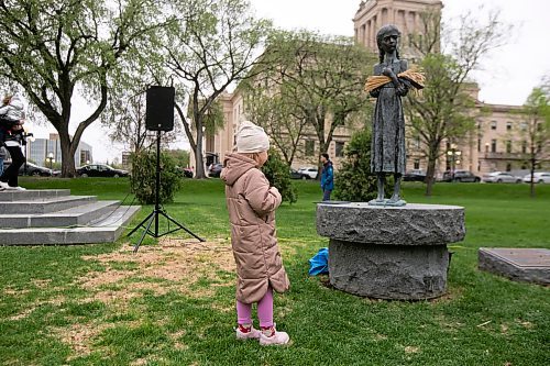 BROOK JONES / WINNIPEG FREE PRESS
Nearly 200 Ukrainians and their supporters gather on the grounds of the Manitoba Legislative Building in Winnipeg, Man., Thursday, May 19, 2023 for Vyshyvanka Day. The annual international holiday is celebrated on the third Thursday of May and is designed to preserve the age-old folk traditions of Ukrainian national clothing, particulary its embroidered clothing. Pictured: Annastasiia Sidletskr looks at the Bitter Memories of Childhood monument, which commemorates the millions of victims of the enforced starvation during the Holodomor Famine Genocide in Ukraine from 1932 to 1933. Many of the surviors immigrated to Canada and settled in Manitoba. 