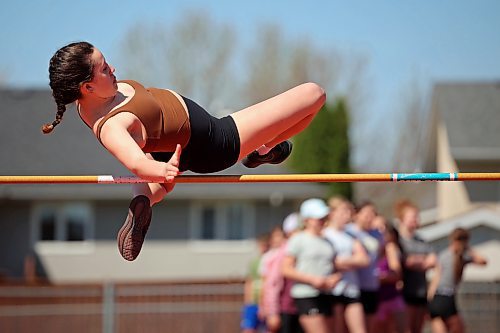Mila Yuel, a Grade 8 student from École Harrison, leaps over the bar while competing in the high jump event at the school’s track and field day at the UCT Stadium on Friday. (Tim Smith/The Brandon Sun)