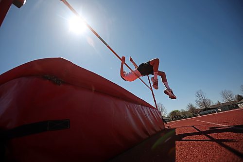 Charlie Gauthier, a Grade 8 student from École Harrison, leaps over the bar while competing in the high jump event at the school’s track and field day at the UCT Stadium on Friday. (Tim Smith/The Brandon Sun)