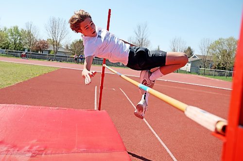 Charlie Gauthier, a Grade 8 student from École Harrison, leaps over the bar while competing in the high jump event at the school’s track and field day at the UCT Stadium on Friday. (Tim Smith/The Brandon Sun)