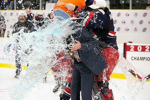 BROOK JONES / WINNIPEG FREE PRESS
The Brooks Bandits (AJHL) defeat the Battlefords North Stars (SJHL) 4-1 to claim the 2023 Centennial Cup at Stride Place in Portage la Prairie, Man., Sunday, May 21, 2023. Pictured: Brooks head coach and general manager Ryan Papaioannou gets the traditional Gatorade shower during the team's Centennial Cup on ice celebration. 