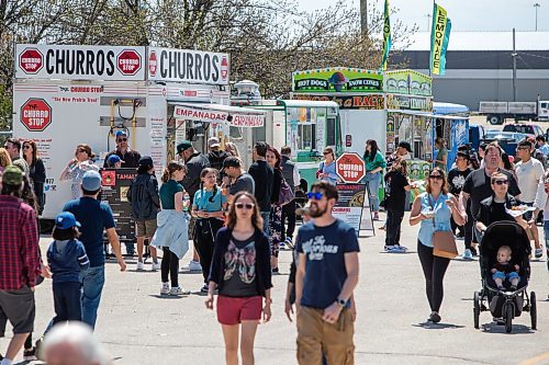 Daniel Crump / Winnipeg Free Press. People take in the first-ever MB Food Truck Battles are at Assiniboia Downs Saturday afternoon. Vendors include food trucks, live music and a play area for kids. May 28, 2022.