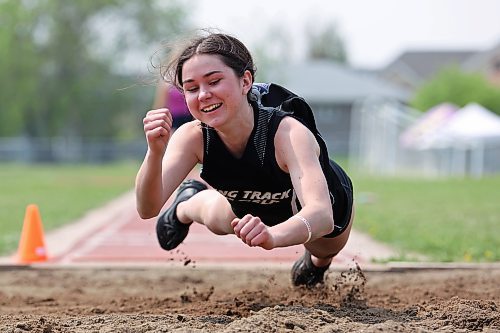 Mackenzie Lyburn of Vincent Massey High School springs forward into the sand after landing during the varsity girls long jump event at the high school track and field city championships on Tuesday. (Tim Smith/The Brandon Sun)