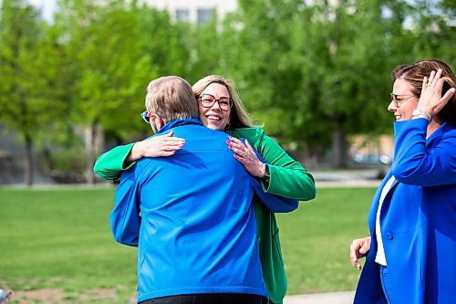 MIKAELA MACKENZIE / WINNIPEG FREE PRESS
 
Families Minister and minister responsible for gender equity Rochelle Squires hugs president of Pride Winnipeg Barry Karlenzig at an announcement about Pride funding at The Forks on Tuesday, May 23, 2023. 

Winnipeg Free Press 2023.