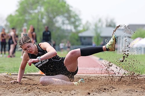 23052023
Juliana Crocker of Vincent Massey High School kicks up sand while landing during the varsity girls long jump event at the High School Track and Field City Finals on Tuesday. 
(Tim Smith/The Brandon Sun)