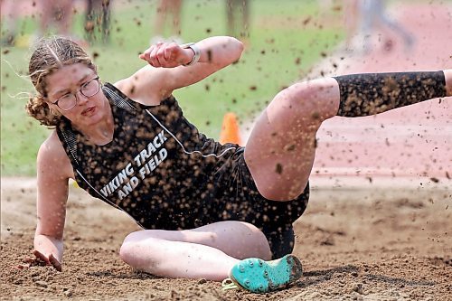 23052023
Juliana Crocker of Vincent Massey High School kicks up sand while landing during the varsity girls long jump event at the High School Track and Field City Finals on Tuesday. 
(Tim Smith/The Brandon Sun)