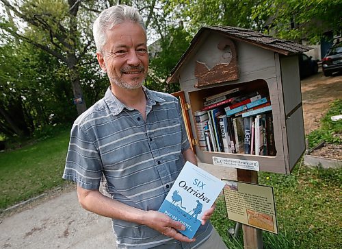 JOHN WOODS / WINNIPEG FREE PRESS
Philipp Schott, local author and veterinarian, is photographed with his new mystery novel, Six Ostriches, at his book exchange outside his home Tuesday, May 23, 2023. 

Reporter: sigurdson