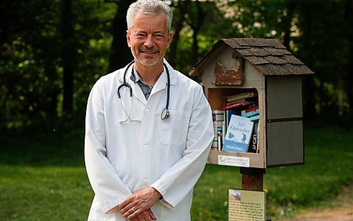 JOHN WOODS / WINNIPEG FREE PRESS
Philipp Schott, local author and veterinarian, is photographed with his new mystery novel, Six Ostriches, at his book exchange outside his home Tuesday, May 23, 2023. 

Reporter: sigurdson