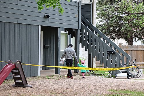 IIU investigators were on-scene at an apartment at 534 Hazel Bay in Portage La Prairie on May 24, 2023 after an 18-year-old man was killed by police earlier that day. Two RCMP officers also remained to secure the scene, at one point lifting police tape to allow neighbouring tenants access to their apartments. (Tyler Searle / Winnipeg Free Press)