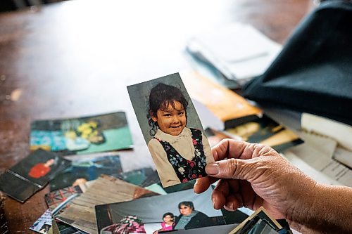 MIKAELA MACKENZIE / WINNIPEG FREE PRESS
 
 Janet Bruyere, grandmother of Fonassa Bruyere (whose body was discovered in a field northwest Winnipeg in 2007), looks at old photos of Fonassa in her home on Sagkeeng First Nation on Tuesday, May 23, 2023. For Shelley story.

Winnipeg Free Press 2023.