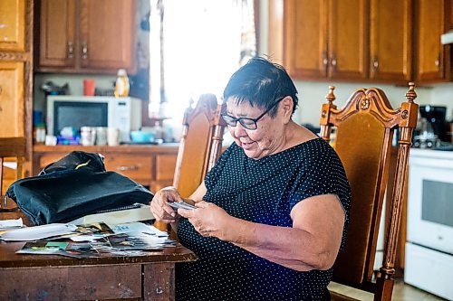 MIKAELA MACKENZIE / WINNIPEG FREE PRESS
 
 Janet Bruyere, grandmother of Fonassa Bruyere (whose body was discovered in a field northwest Winnipeg in 2007), looks at old photos of Fonassa in her home on Sagkeeng First Nation on Tuesday, May 23, 2023. For Shelley story.

Winnipeg Free Press 2023.