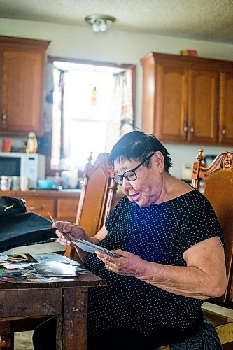 MIKAELA MACKENZIE / WINNIPEG FREE PRESS
 
 Janet Bruyere, grandmother of Fonassa Bruyere (whose body was discovered in a field northwest Winnipeg in 2007), looks at old photos of Fonassa in her home on Sagkeeng First Nation on Tuesday, May 23, 2023. For Shelley story.

Winnipeg Free Press 2023.