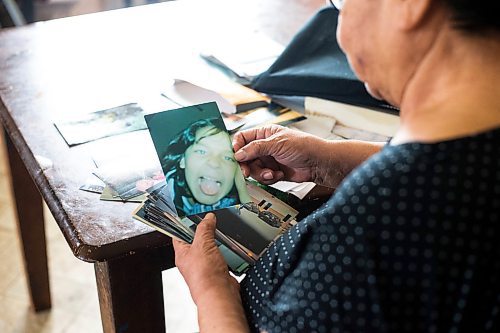 MIKAELA MACKENZIE / WINNIPEG FREE PRESS
 
 Janet Bruyere, grandmother of Fonassa Bruyere (whose body was discovered in a field northwest Winnipeg in 2007), looks at old photos of Fonassa in her home on Sagkeeng First Nation on Tuesday, May 23, 2023. For Shelley story.

Winnipeg Free Press 2023.