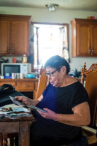 MIKAELA MACKENZIE / WINNIPEG FREE PRESS
 
 Janet Bruyere, grandmother of Fonassa Bruyere (whose body was discovered in a field northwest Winnipeg in 2007), looks at old photos of Fonassa in her home on Sagkeeng First Nation on Tuesday, May 23, 2023. For Shelley story.

Winnipeg Free Press 2023.