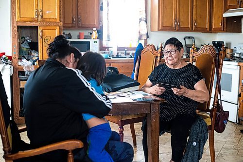 MIKAELA MACKENZIE / WINNIPEG FREE PRESS
 
 Janet Bruyere, grandmother of Fonassa Bruyere (whose body was discovered in a field northwest Winnipeg in 2007), looks through old family photos of Fonassa with her granddaughter, Crystal McLean, and great-grandson, Christian Sinclair (three), at her home on Sagkeeng First Nation on Tuesday, May 23, 2023. For Shelley story.

Winnipeg Free Press 2023.