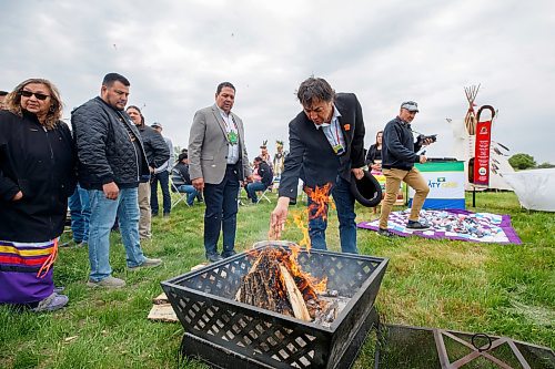 Mike Deal / Winnipeg Free Press
Former Long Plain First Nation Chief Dennis Meeches, puts an offering of tobacco into the Ceremonial Fire during a blessing of the land at the Treaty One Nation Land Reclamation Ceremony for the Naawi-Oodena Treaty One Jointly Held lands, on the former Kapyong Barracks lands in Winnipeg, Wednesday morning.
230524 - Wednesday, May 24, 2023.