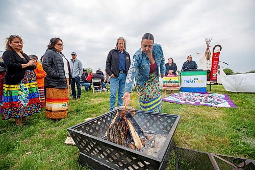 Mike Deal / Winnipeg Free Press
Long Plain First Nation Chief Kyra Wilson puts an offering of tobacco into the Ceremonial Fire during a blessing of the land at the Treaty One Nation Land Reclamation Ceremony for the Naawi-Oodena Treaty One Jointly Held lands, on the former Kapyong Barracks lands in Winnipeg, Wednesday morning.
230524 - Wednesday, May 24, 2023.