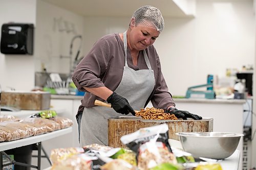 BROOK JONES / WINNIPEG FREE PRESS
Lady Di's Snackers owner Dianna Upton seasons pretzels  with dill pickle flavour while working in her commerical space in Anola, Man., Wednesday, May 24, 2023. Upton buys pre-made pretzles and then spices them up. She has four flavours, which include: Zesty Original, Parmesan Herb &amp; Garlic, Dill Pickle, and Rosemary &amp; Sea Salt. 