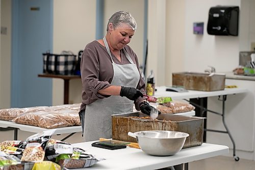 BROOK JONES / WINNIPEG FREE PRESS
Lady Di's Snackers owner Dianna Upton seasons pretzels with dill pickle flavour while working in her commerical space in Anola, Man., Wednesday, May 24, 2023. Upton buys pre-made pretzles and then spices them up. She has four flavours, which include: Zesty Original, Parmesan Herb &amp; Garlic, Dill Pickle, and Rosemary &amp; Sea Salt. 