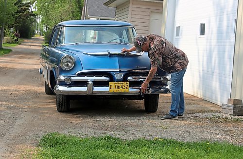 Bob Chambers polishes the chrome on his 1956 Dodge Regent four-door sedan with rear fins and PowerFlite two-speed automatic transmission in Boissevain on Thursday. (Photos by Michele McDougall/The Brandon Sun) 