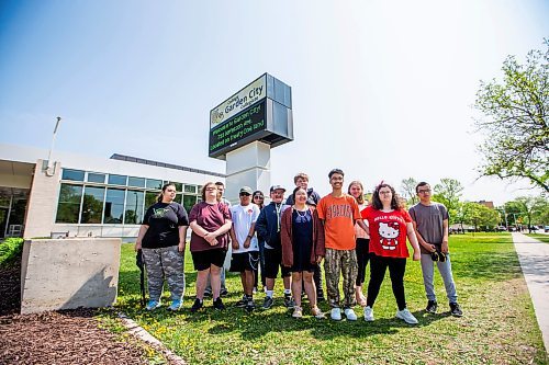 MIKAELA MACKENZIE / WINNIPEG FREE PRESS
 
Orion Remoquillo (centre, orange shirt) poses with Stephanie Halabura (left), Logan Brown, Kaylum Kostiuk, Marcus Velasco, Erica Sanderson-Longclaws, Devin Bell, Sophia Ly, Kade Plant, Amanda Finlayson, Chantel Rego, and Jonathan Bagalay (some of the students who he volunteers with) at Garden City Collegiate on Thursday, May 25, 2023. Orion was recently recognized with one of 15 Terry Fox Humanitarian Awards. For Aaron Epp story.

Winnipeg Free Press 2023.