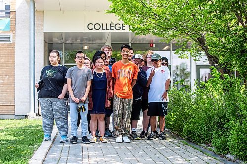 MIKAELA MACKENZIE / WINNIPEG FREE PRESS
 
Orion Remoquillo, a grade 12 student who volunteers with students with special needs (centre, orange shirt), poses for a photo with some of the students he volunteers with at Garden City Collegiate on Thursday, May 25, 2023. Orion was recently recognized with one of 15 Terry Fox Humanitarian Awards. For Aaron Epp story.

Winnipeg Free Press 2023.