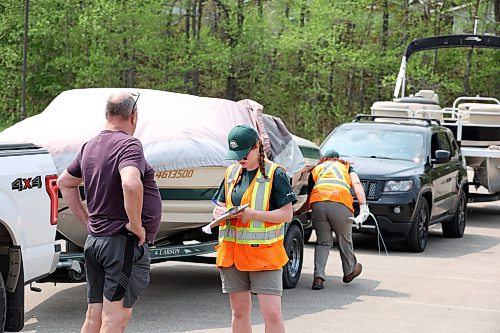 25052023
Parks Canada staff inspect and tag boats in Wasagaming on Thursday as part of new Parks Canada restrictions for boaters on Clear Lake. The new rules state boaters must pass an initial inspection before June 15 to receive a permit to use a trailered vessel in Clear Lake and cannot have used their watercraft in any other body of water this year. The restrictions are meant to prevent the spread of invasive species into the lake.
(Tim Smith/The Brandon Sun)